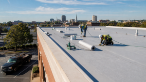 Commercial roofing crew installing a TPO membrane roof on a commercial building in Columbus, Georgia
